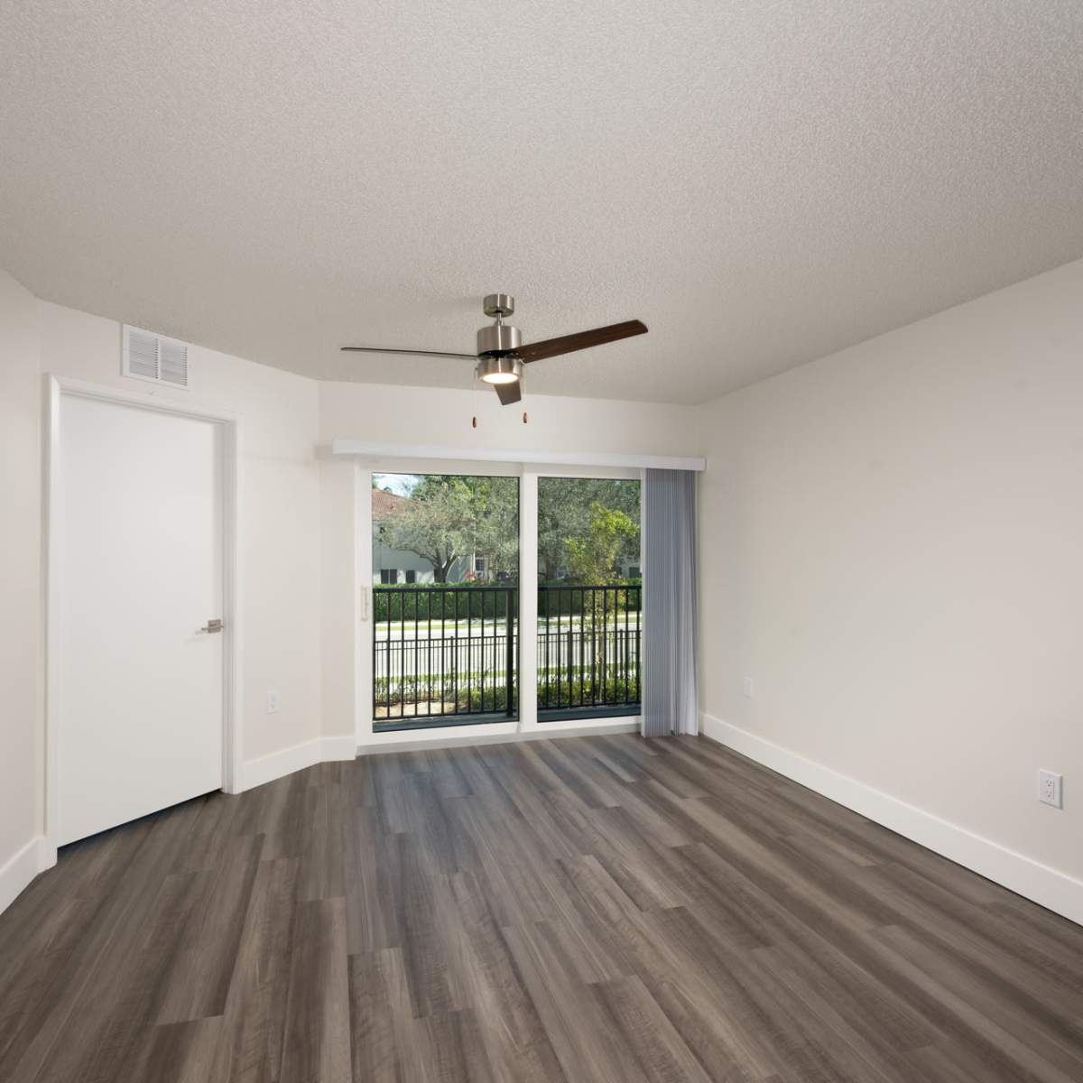 Spacious and well-lit apartment with vinyl plank flooring at Ernie Martin Villas in Miami, Florida