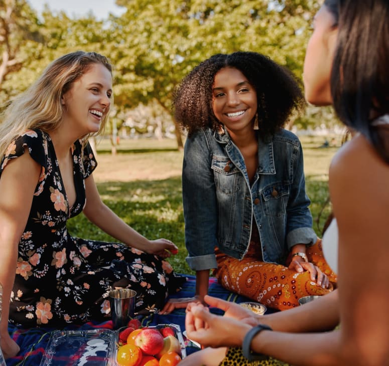 Friends gather for a picnic at Town Center Park, near Strata Apartments in Denver, Colorado