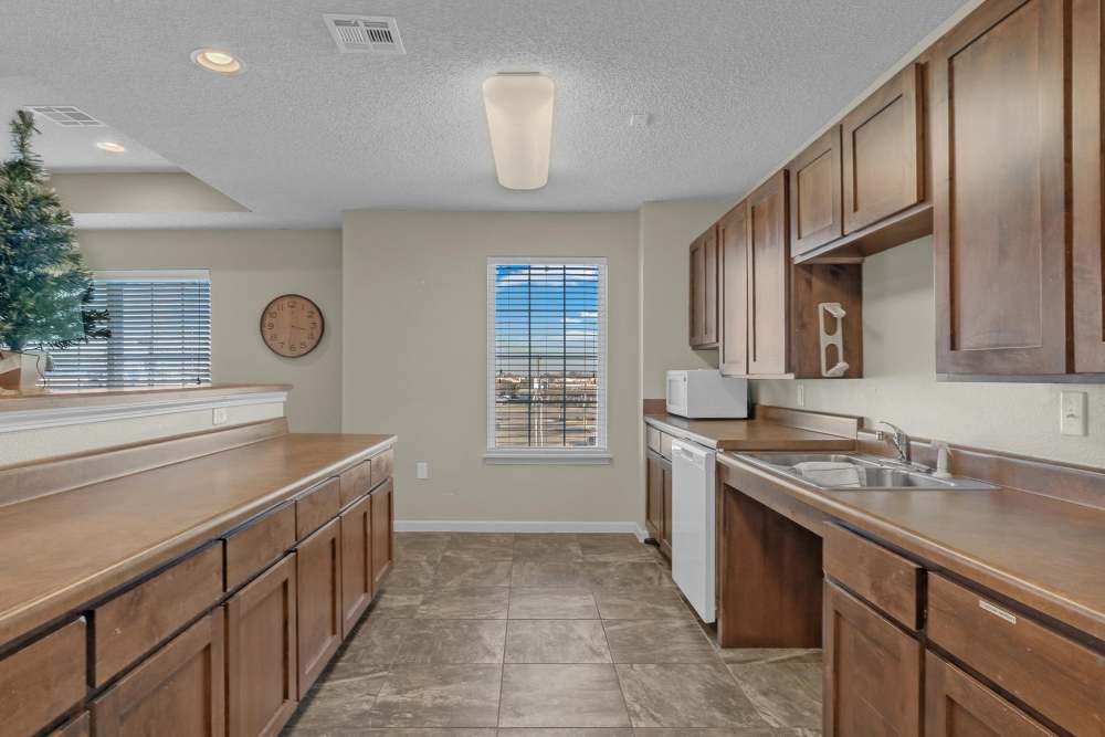 Clubhouse kitchen with white appliances at Hartford Villas in Broken Arrow, Oklahoma