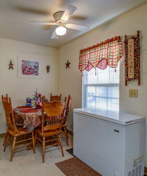 Dining table and refrigerator in the townhome at Yellowbud Place in Moorefield, West Virginia