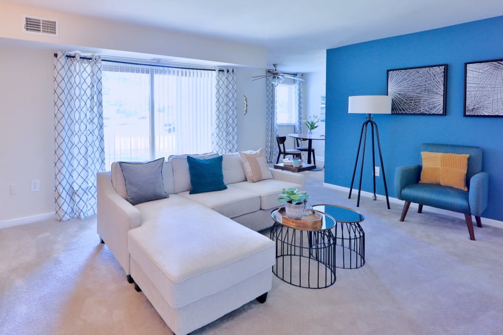 Model living room with an accent wall at Gwynn Oaks Landing Apartments & Townhomes in Baltimore, Maryland