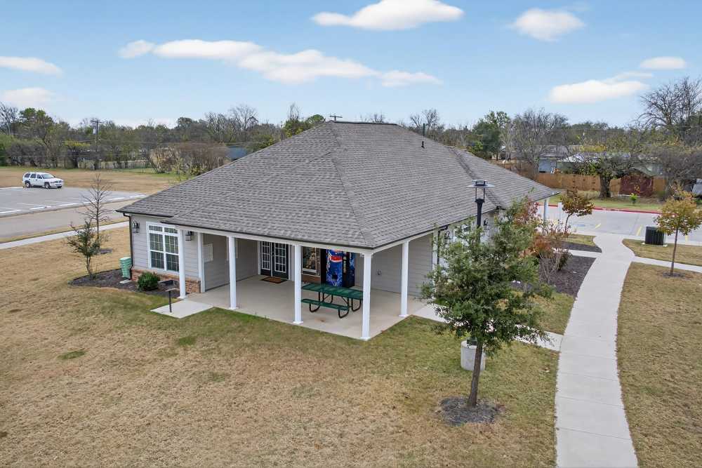 Charming community center with lush landscaping at Lakewood Crossing in Granbury, Texas.