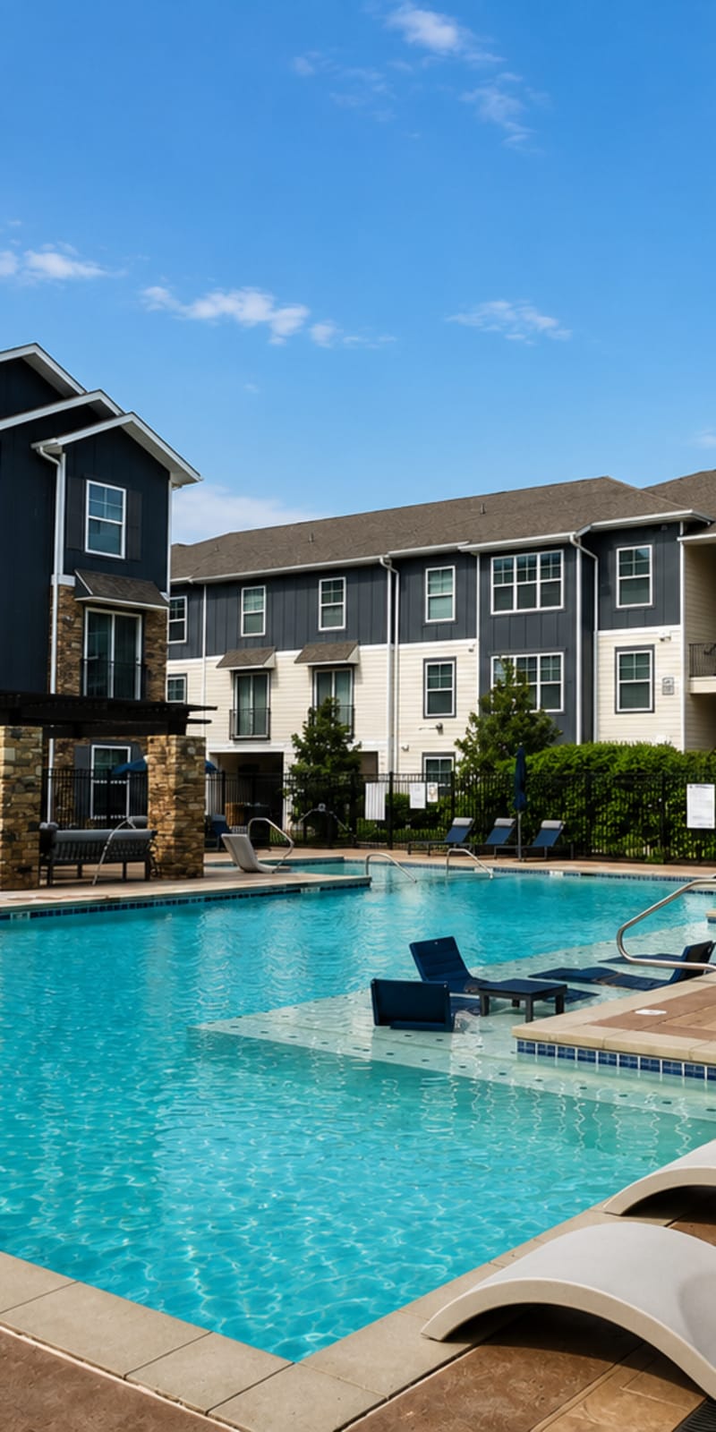 Swimming pool and apartment buildings at The Den in Columbia, Missouri