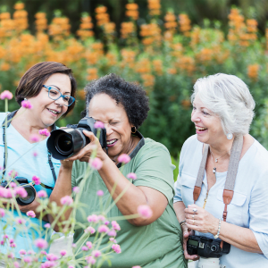 Resident taking a picture of some flowers with a large camera at Hanover Place in Tinley Park, Illinois