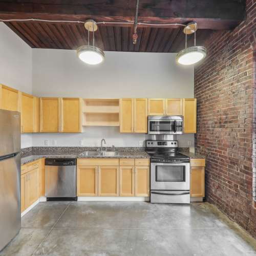 Kitchen with microwave and dishwasher at Stadium Loft Apartments in Saint Louis, Missouri
