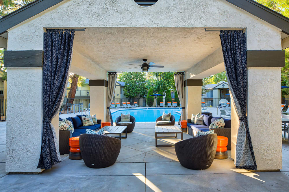 Covered cabana-style lounge area near the swimming pool at Mountain Vista in Victorville, California