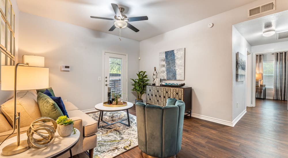 Resident living space with wood-style flooring at Lakebridge Apartments in Houston, Texas