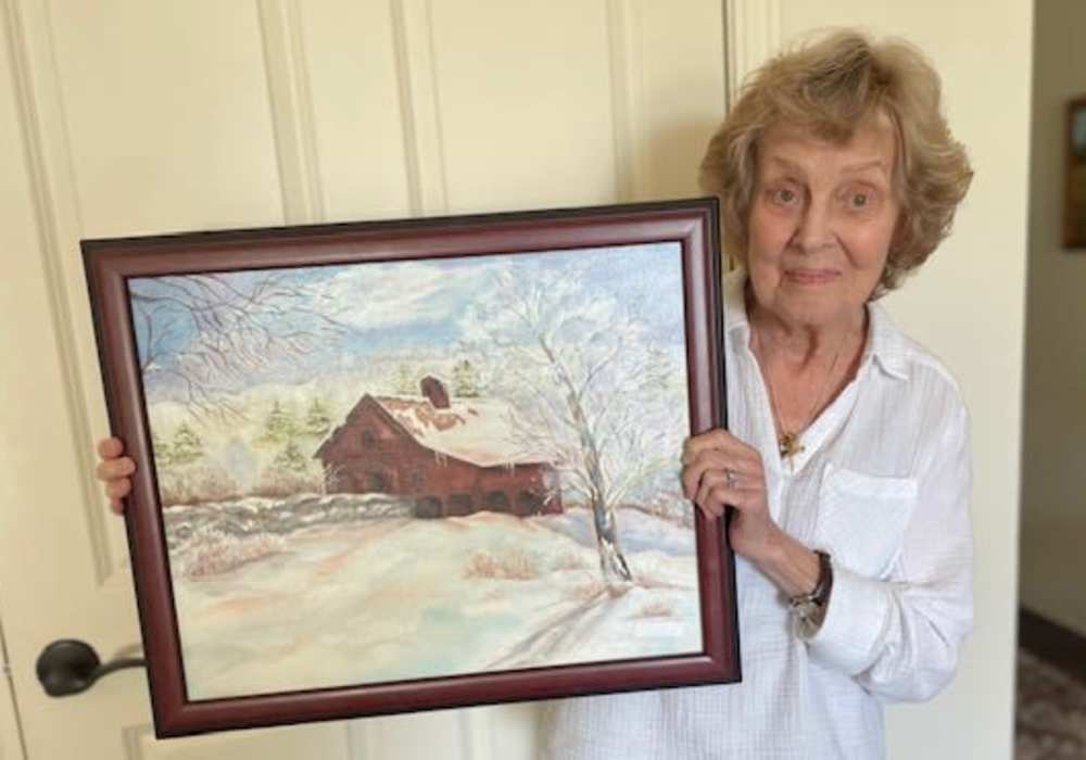 Resident with a painting at Truewood by Merrill, Keller in Keller, Texas