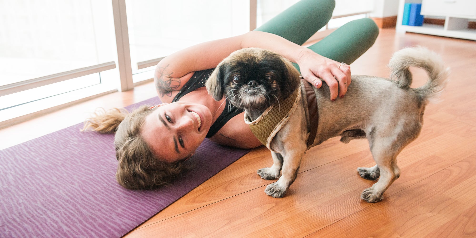 Happy Woman Doing Yoga with Dog - Pet friendly at Yard 8 Midtown in Midtown Miami, Florida