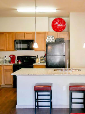 Gourmet kitchen with island seating at Anatole at City View in Lubbock, Texas