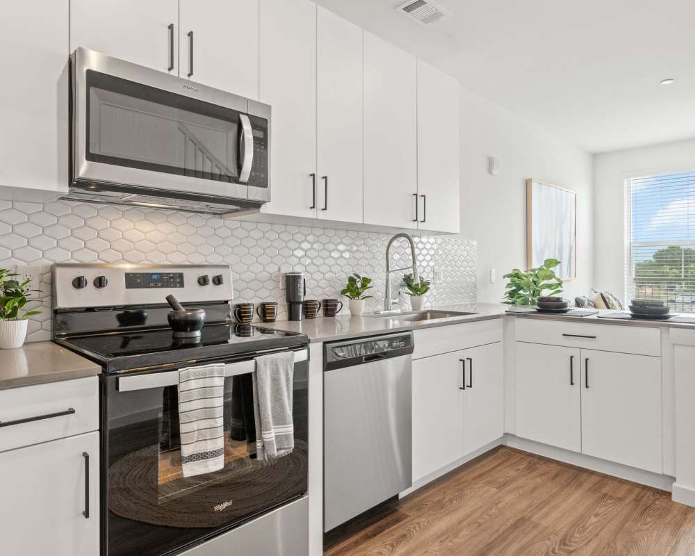 Large, well-equipped kitchen with wood flooring in a model home at The Plaza Taos in Chandler, Arizona