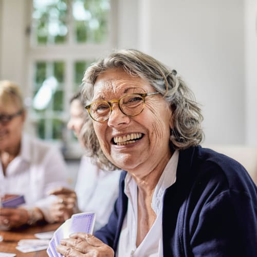 Resident smiling at breakfast at Oxford Springs Tulsa Memory Care in Tulsa, Oklahoma