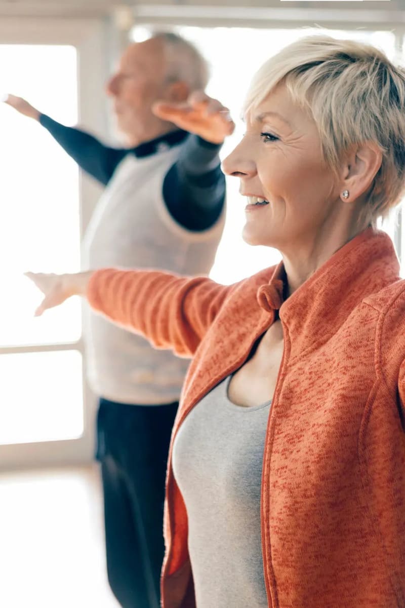 Resident couple doing yoga at Village on the Park Steeplechase in Houston, Texas