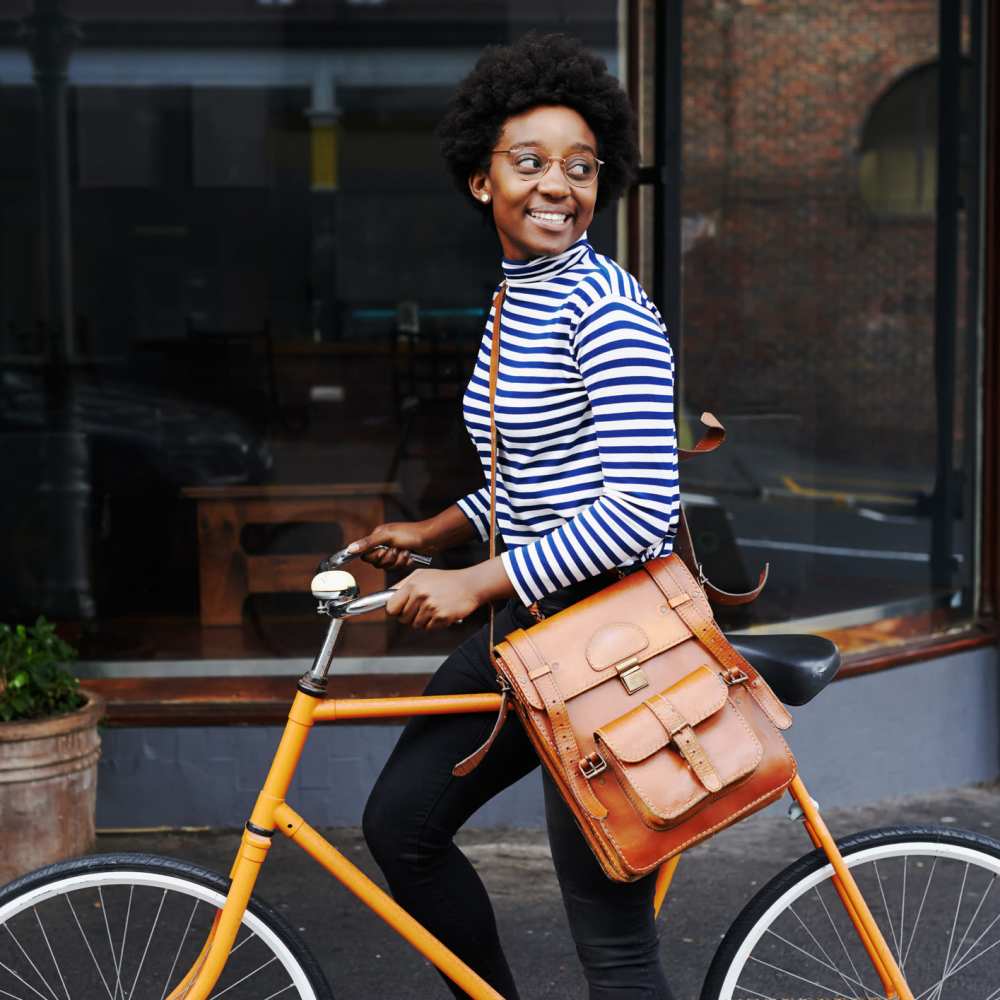 Brightly lit street scene with woman on bicycle at The Simone in Silver Spring, Maryland