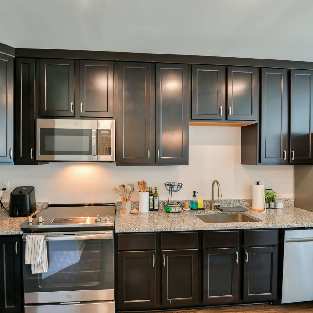 Kitchen with dark finished wood cabinets at Crossroad Towers, Pittsburgh, Pennsylvania