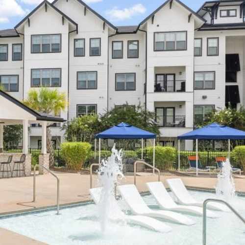 Resort-style salt water pool with in-pool lounge chairs at Palmetto Exchange in Ladson, South Carolina