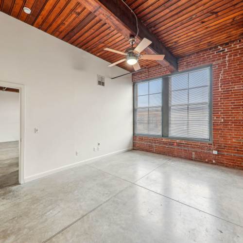Unfurnished bedroom with large window at Stadium Loft Apartments in Saint Louis, Missouri