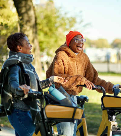 People with bicycles outdoors at Pleasant View Townhomes in Baltimore, Maryland