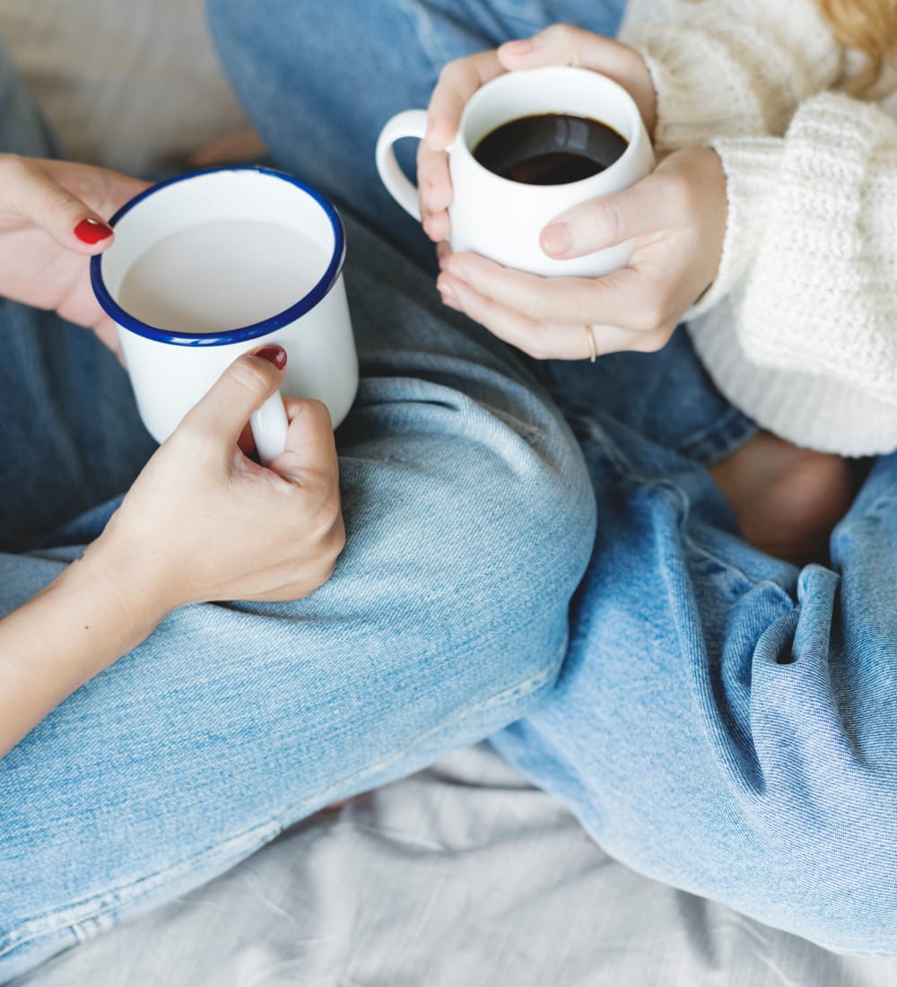 Residents chatting over coffee in their new home at Sofi at 50 Forest in Stamford, Connecticut