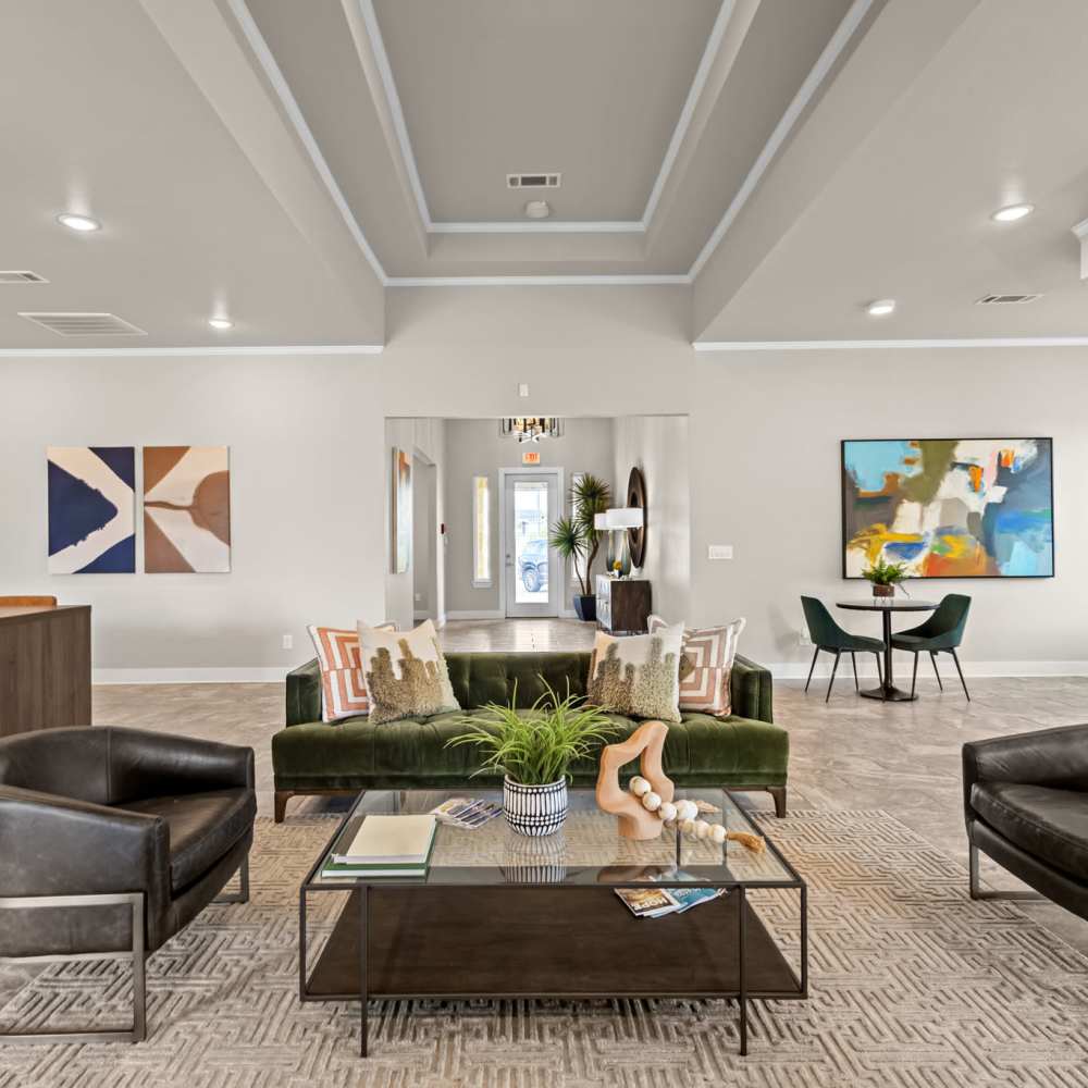 Community clubhouse with large couch, chairs and coffee table at Deer Park in Athens, Texas