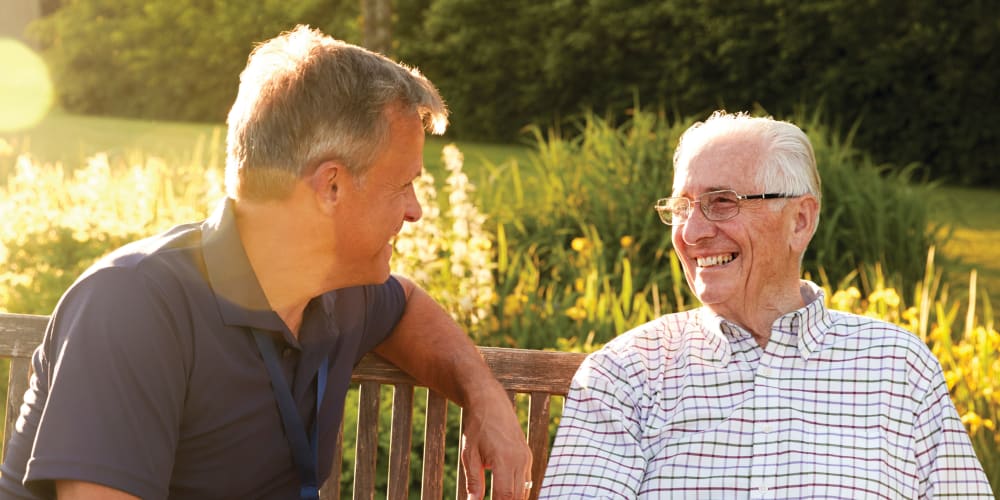 Resident and friend sitting outdoors at Anthology of King of Prussia in King of Prussia, Pennsylvania