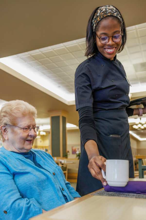 Team member serving coffee at Merrill Gardens in Seattle, Washington