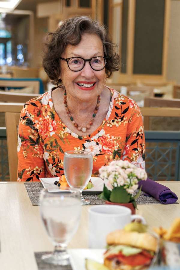 Resident laughing in dining room at Merrill Gardens in Seattle, Washington