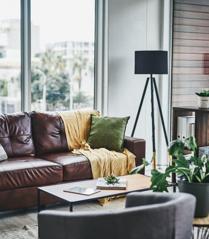 Model living space with leather couch at Chisholm Pointe in Oklahoma City, Oklahoma