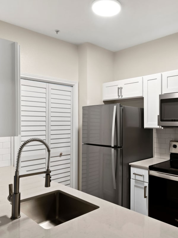 Kitchen with stainless-steel appliances at Lantower Round Rock in Round Rock, Texas