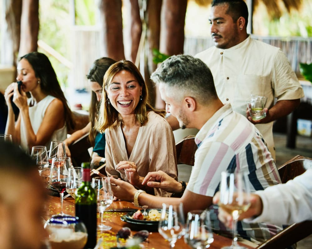 Residents enjoying dinner together outside at San Leandro Racquet Club in San Leandro, California