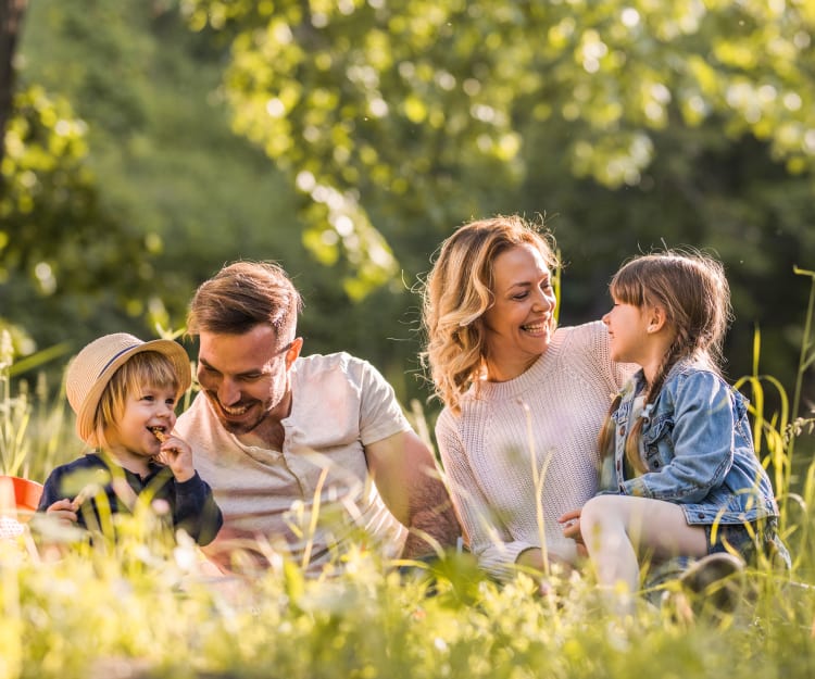 Happy family at a park in San Jose, California near Valley West Apartments