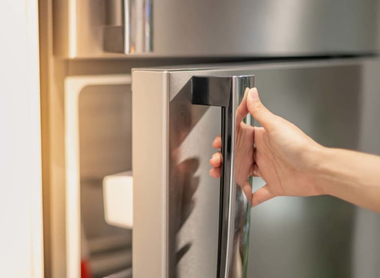 A refrigerator door getting opened at Pomeroy Lane Cooperative in Amherst,Massachusetts