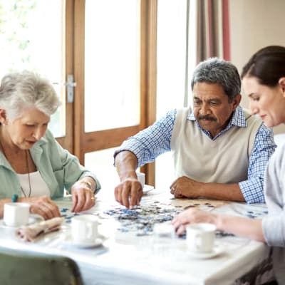 A family putting a puzzle together at Chandler's Square Retirement Community in Anacortes, Washington