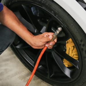 An {location_name}} technician maintains correct tire pressure