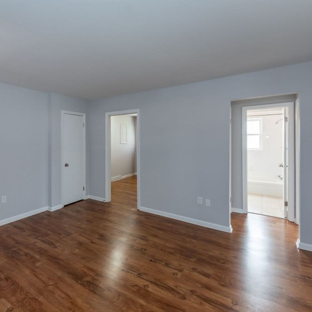 Unfurnished living room with wood-style flooring at Signal Point Apartments in Mechanicsville, Virginia
