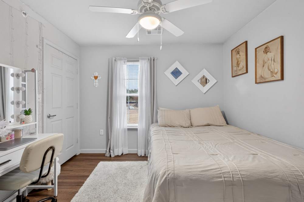Charming bedroom with soft natural light and stylish decor at Lakewood Crossing in Granbury, Texas.