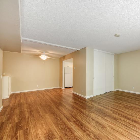 Spacious living room with wood-style flooring at Fayette Arms Apartments in Mountain View, California
