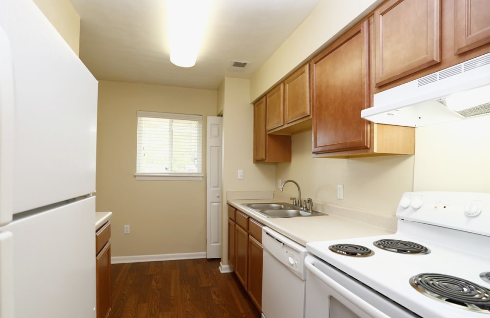 An apartment kitchen with a dishwasher at Honeytree Apartments in Raleigh, North Carolina