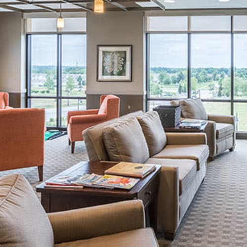 Comfy couches in resident community area at First & Main of Auburn Hills in Auburn Hills, Michigan