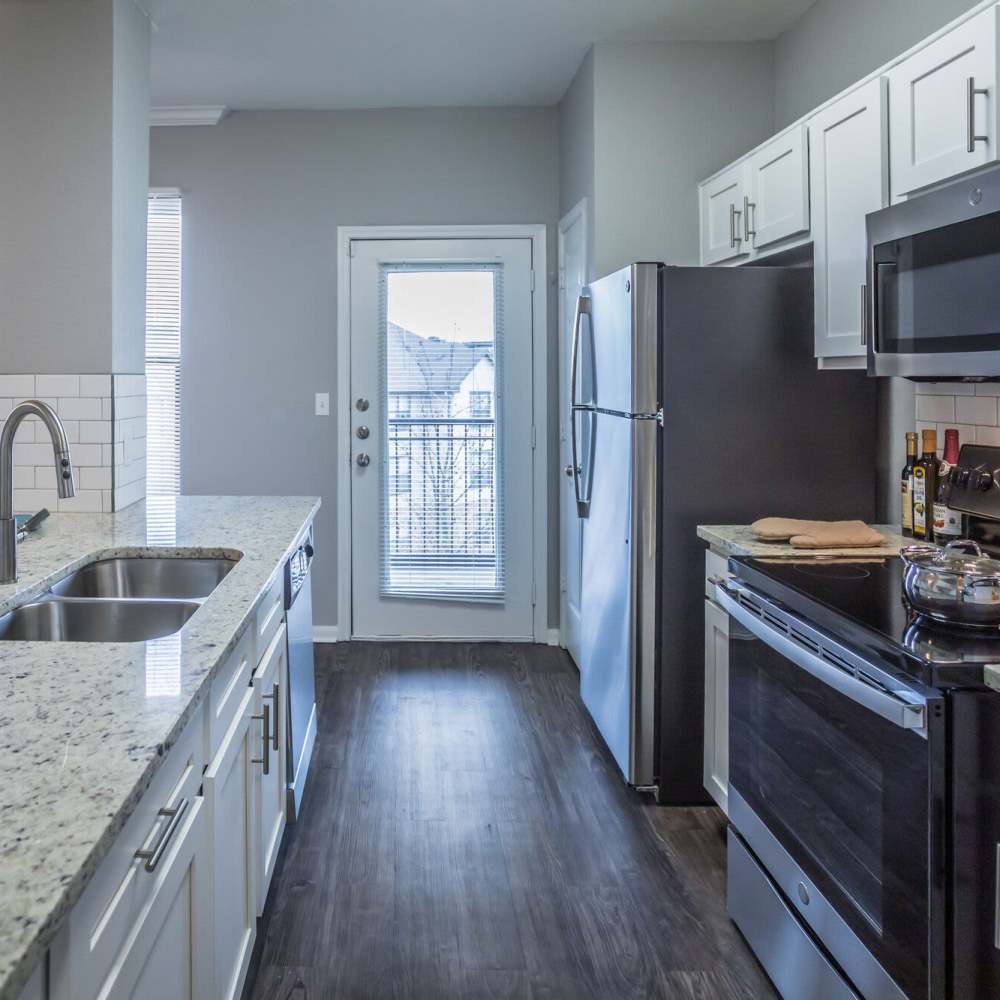 Modern kitchen with close access to balcony at Stonebridge at the Ranch Apartments in Little Rock, Arkansas