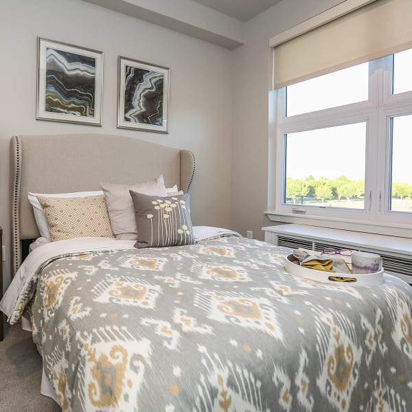Furnished bedroom with a large bed inside an apartment at Quail Park at Morrison Ranch in Gilbert, Arizona