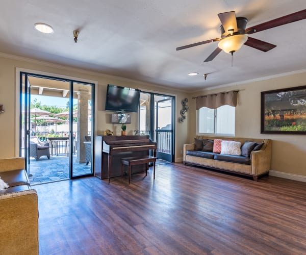 Lounge area and patio access at Pacifica Senior Living Santa Barbara in Santa Barbara, California
