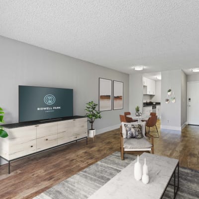 Well-decorated interior with open concept layout and hardwood floors in a model home at Bidwell Park Fremont in Fremont, California