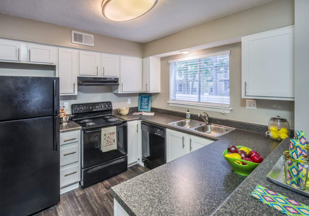 Kitchen with black appliances and white cabinetry at Heron on the Bluffs in Savannah, Georgia 