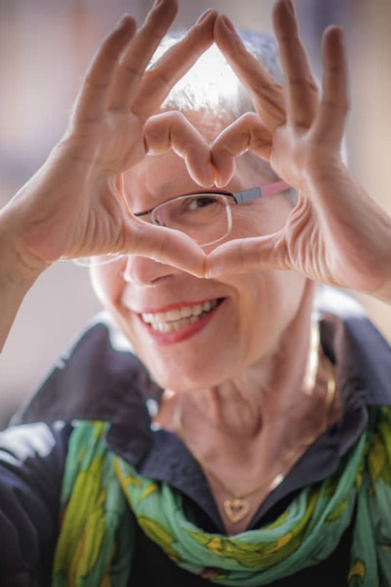 Resident forming a heart with her hands at Montello Care Center in Montello, Wisconsin