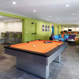 Clubhouse with pool table at UCA Apartment Homes in Fullerton, California