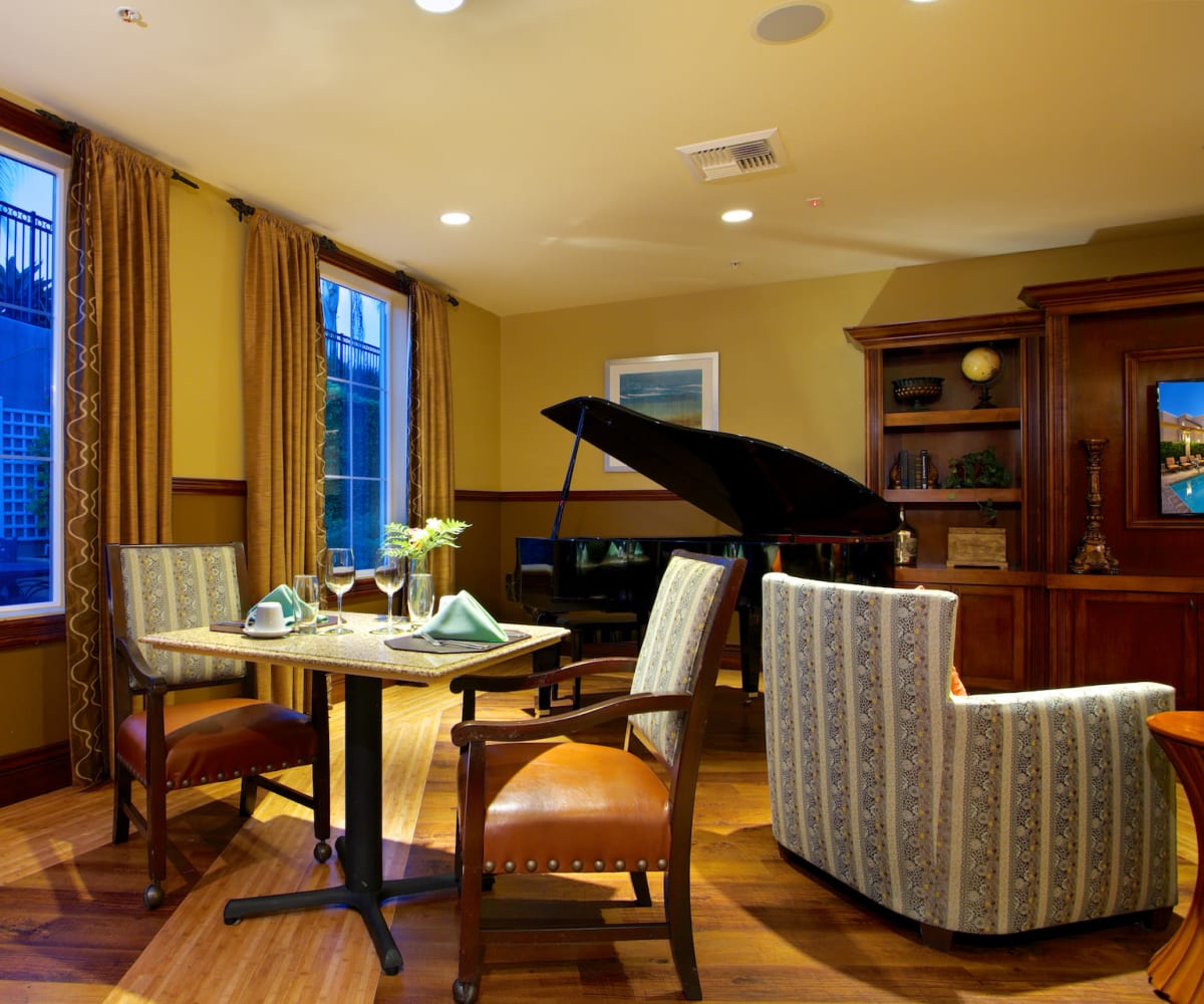 Lounge area with a dining table and piano at Meridian at Lake San Marcos in San Marcos, California