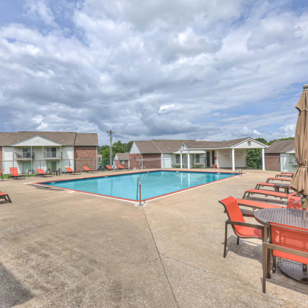 Community swimming pool with lounge chairs at Village Crest Apartment Homes in Smyrna, Tennessee