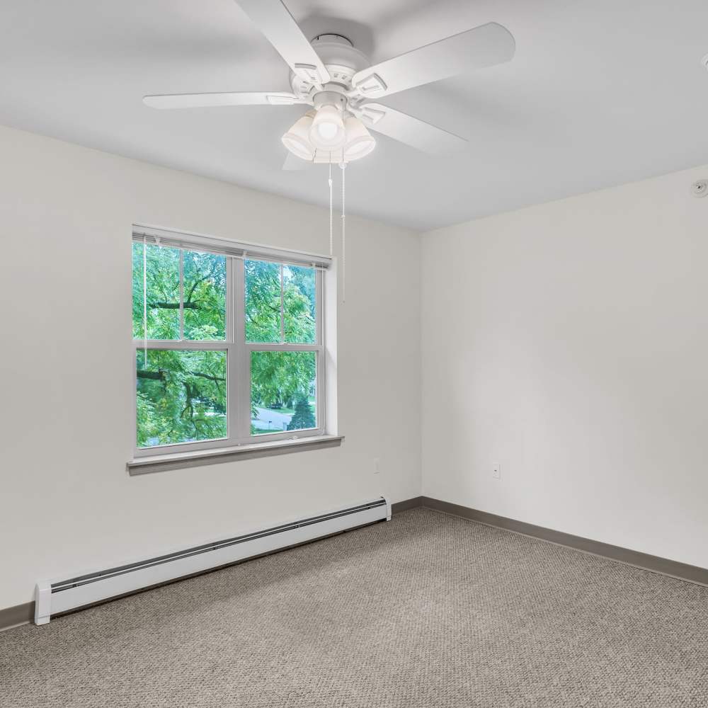 Unfurnished living room with air condition and large window at Residences on Main in Twin Lakes, Wisconsin