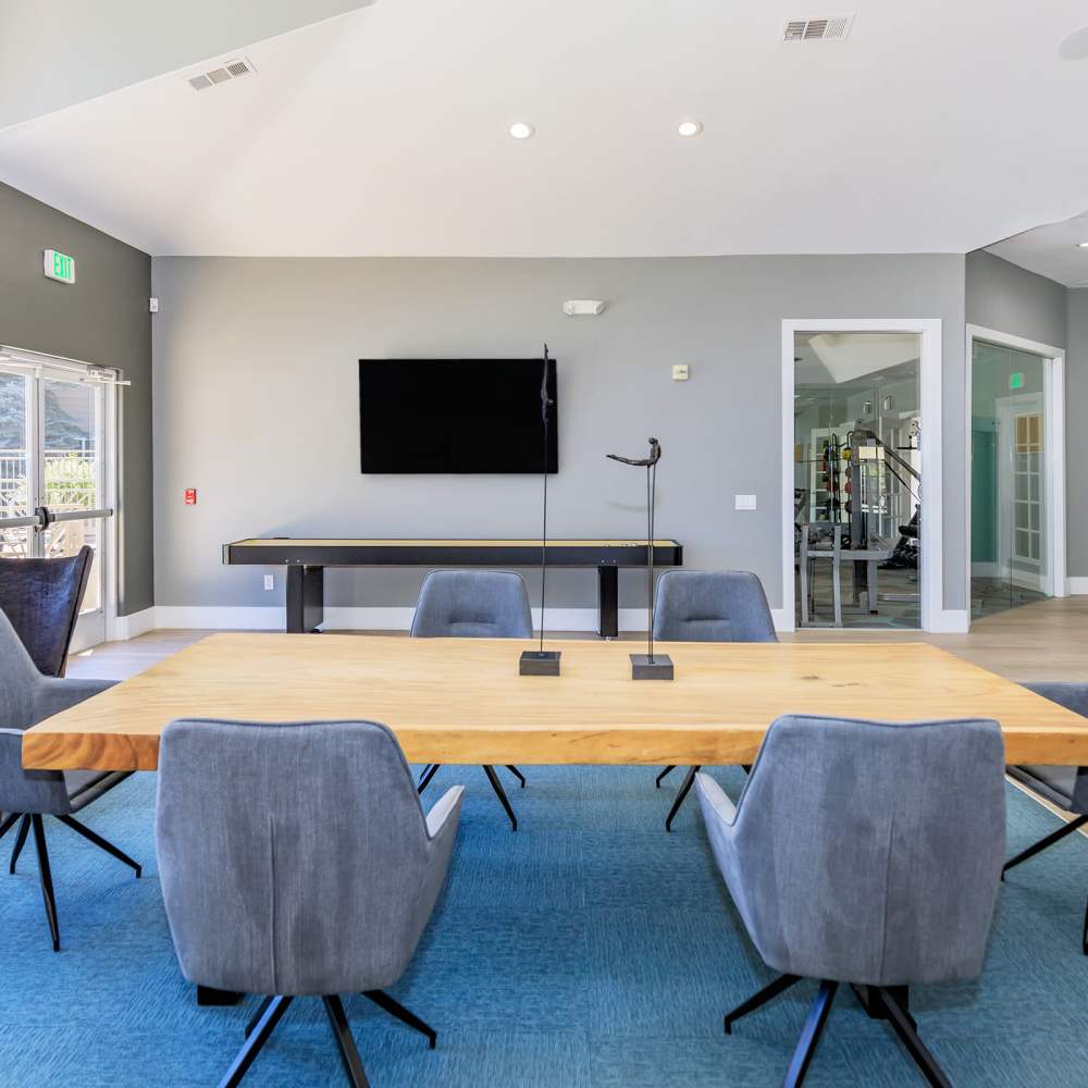 Seating area with television in clubhouse at One Belmar Place in Lakewood, Colorado